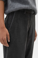 Profile view of model wearing the Oroton Fine Corduroy Pant in Washed Black and 97% cotton and 3% spandex blend fabric for Women .