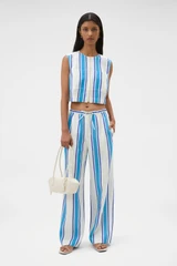 Profile view of model wearing the Oroton Shore Stripe Pyjama Pant in Sea Blue and 100% heavy linen fabric for Women .