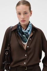 Profile view of model wearing the Oroton The Lightwater Scarf in Midnight Blue and 100% silk twill fabric for Women .