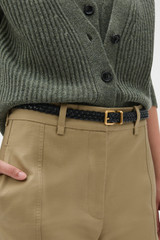 Profile view of model wearing the Oroton Remi Woven 20MM Belt in Black and Premium soft crackle leather for Women .