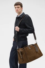 Profile view of model wearing the Oroton Paxton Suede Weekender in Husk Brown and Premium Grade A velvet-finish cow suede leather for Men .