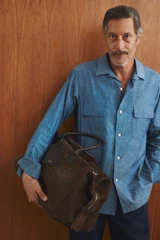 Profile view of model wearing the Oroton Paxton Suede Weekender in Husk Brown and Premium Grade A velvet-finish cow suede leather for Men .