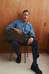 Profile view of model wearing the Oroton Paxton Suede Weekender in Husk Brown and Premium Grade A velvet-finish cow suede leather for Men .