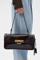 Profile view of model wearing the Oroton Finn Crackle Broguing Large Day Bag in Dark Chocolate and Premium crackle leather for Women .