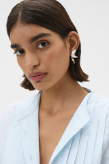 Profile view of model wearing the Oroton Magnolia Studs in Worn Gold/White and Brass material for Women .
