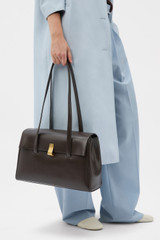 Profile view of model wearing the Oroton Etta Work Bag in Dark Chocolate and Premium epi leather for Women .