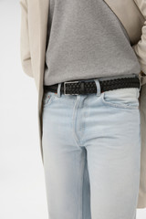 Profile view of model wearing the Oroton Freddie Woven 35MM Belt in Black and Premium smooth cow leather for Men .