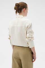 Profile view of model wearing the Oroton Lace Trim Shirt in Whipped Cream and 100% heavy linen fabric for Women .