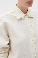 Profile view of model wearing the Oroton Lace Trim Shirt in Whipped Cream and 100% heavy linen fabric for Women .
