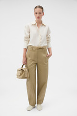 Profile view of model wearing the Oroton Lace Trim Shirt in Whipped Cream and 100% heavy linen fabric for Women .