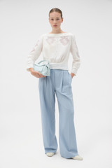 Profile view of model wearing the Oroton Drawn Thread Detail Blouse in White and 100% linen fabric for Women .