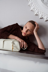 Profile view of model wearing the Oroton Drawn Thread Detail Blouse in Dark Chocolate and 100% linen fabric for Women .