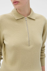 Profile view of model wearing the Oroton Long Sleeve Zip Polo in Haystack and 100% mid-gauge merino wool fabric for Women .