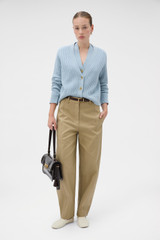 Profile view of model wearing the Oroton V-Neckline Cardigan in Twilight Blue and 100% mid-gauge merino wool fabric for Women .