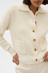 Profile view of model wearing the Oroton Waffle Cardigan in Cream and 100% super soft merino wool fabric for Women .