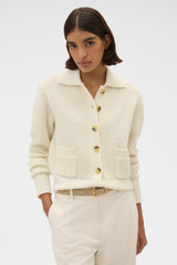 Profile view of model wearing the Oroton Waffle Cardigan in Cream and 100% super soft merino wool fabric for Women .