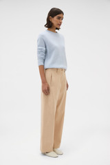 Profile view of model wearing the Oroton Barrel Twill Leg Pant in Biscotti and 100% cotton fabric for Women .