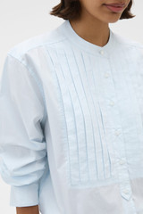 Profile view of model wearing the Oroton Washed Pleated Shirt in Soft Blue and 100% soft cotton fabric for Women .