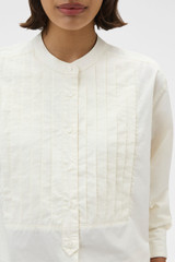Profile view of model wearing the Oroton Washed Pleated Shirt in Whipped Cream and 100% soft cotton fabric for Women .