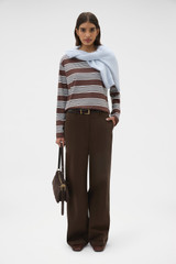 Profile view of model wearing the Oroton Long Sleeve Stripe Tee in Chocolate and 100% cotton fabric for Women .