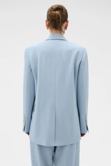Profile view of model wearing the Oroton Double Breasted Blazer in Twilight Blue and 95% wool and 5% Lycra blend fabri for Women .