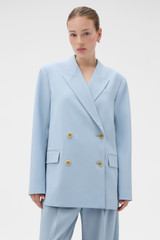 Profile view of model wearing the Oroton Double Breasted Blazer in Twilight Blue and 95% wool and 5% Lycra blend fabri for Women .