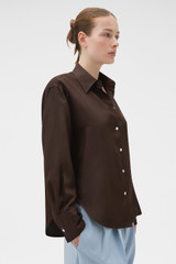 Profile view of model wearing the Oroton Long Sleeve Shirt in Dark Chocolate and 100% silk fabric for Women .