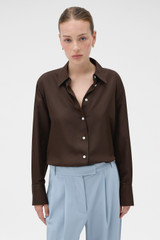 Profile view of model wearing the Oroton Long Sleeve Shirt in Dark Chocolate and 100% silk fabric for Women .
