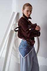 Profile view of model wearing the Oroton Long Sleeve Shirt in Dark Chocolate and 100% silk fabric for Women .