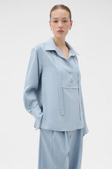 Profile view of model wearing the Oroton Half Placket Button Shirt in Twilight Blue and 100% Fuji silk fabric for Women .