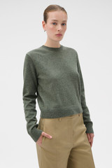 Profile view of model wearing the Oroton Wrap Scarf Knit in Soft Khaki and 100% mid-gauge merino wool fabric for Women .