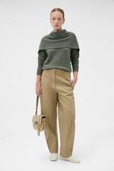 Profile view of model wearing the Oroton Wrap Scarf Knit in Soft Khaki and 100% mid-gauge merino wool fabric for Women .