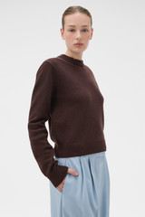 Profile view of model wearing the Oroton Embellished Rib Knit Crew in Dark Chocolate and 100% merino wool fabric for Women .