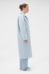 Profile view of model wearing the Oroton Essential Mac in Soft Smoke Blue and 77% cotton and 23% linen blend fabric for Women .