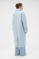 Profile view of model wearing the Oroton Essential Mac in Soft Smoke Blue and 77% cotton and 23% linen blend fabric for Women .