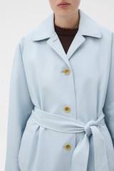 Profile view of model wearing the Oroton Essential Mac in Soft Smoke Blue and 77% cotton and 23% linen blend fabric for Women .
