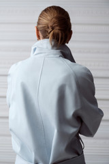 Profile view of model wearing the Oroton Essential Mac in Soft Smoke Blue and 77% cotton and 23% linen blend fabric for Women .