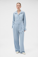 Profile view of model wearing the Oroton Pleat Detail Pant in Twilight Blue and 95% wool and 5% Lycra blend fabri for Women .