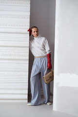 Profile view of model wearing the Oroton Pleat Detail Pant in Twilight Blue and 95% wool and 5% Lycra blend fabri for Women .