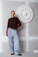 Profile view of model wearing the Oroton Pleat Detail Pant in Twilight Blue and 95% wool and 5% Lycra blend fabri for Women .