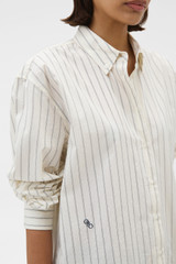 Profile view of model wearing the Oroton Dobby Stripe Shirt in Whipped Cream and 100% cotton fabric for Women .
