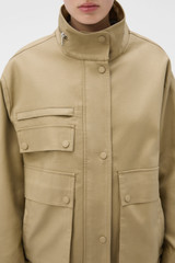 Profile view of model wearing the Oroton Utility Parka in Haystack and 100% cotton fabric for Women .