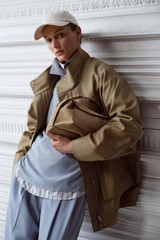 Profile view of model wearing the Oroton Utility Parka in Haystack and 100% cotton fabric for Women .