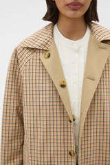 Profile view of model wearing the Oroton Reversible Check Mac in Camel and 100% soft cotton fabric for Women .