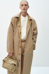 Profile view of model wearing the Oroton Reversible Check Mac in Camel and 100% soft cotton fabric for Women .