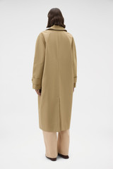Profile view of model wearing the Oroton Reversible Check Mac in Camel and 100% soft cotton fabric for Women .