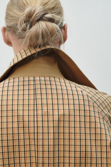 Profile view of model wearing the Oroton Reversible Check Mac in Camel and 100% soft cotton fabric for Women .
