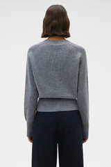Profile view of model wearing the Oroton Rib Knit Henley in Grey Marle and 100% supersoft merino wool fabric for Women .