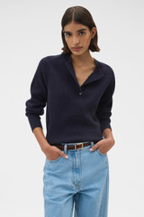 Profile view of model wearing the Oroton Rib Knit Henley in North Sea and 100% supersoft merino wool fabric for Women .