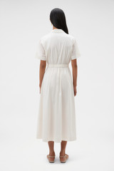 Profile view of model wearing the Oroton Ruffle Detail Shirt Dress in Cream and 100% cotton voile fabric for Women .